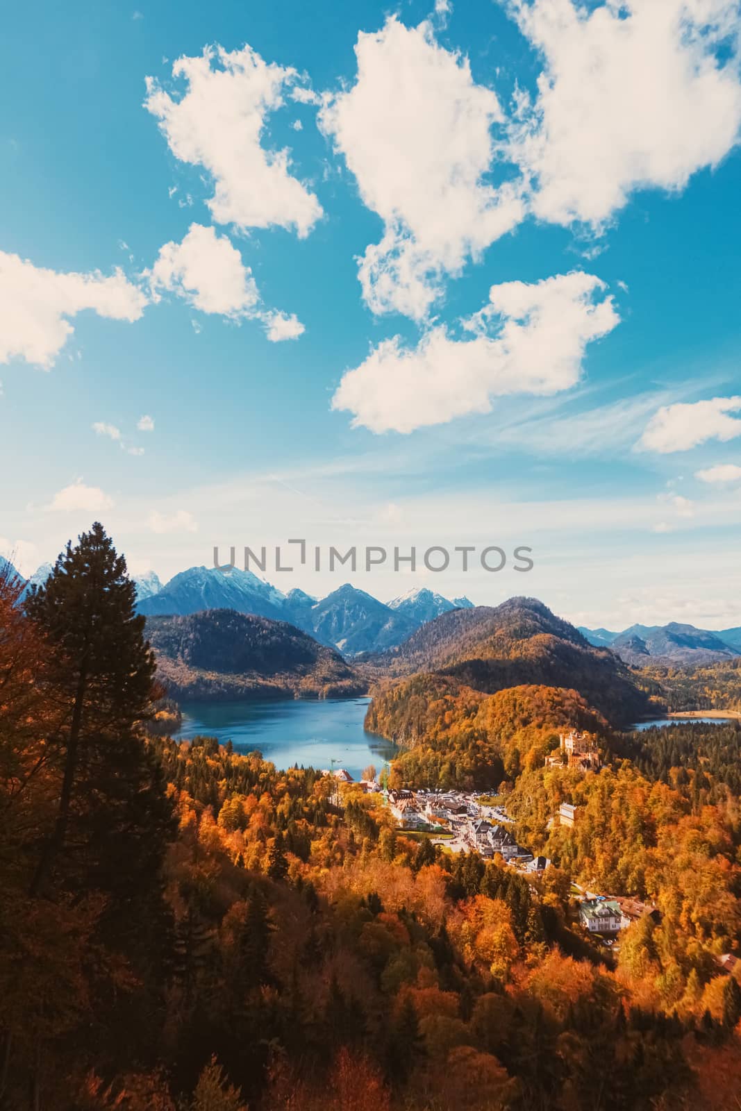 Beautiful nature of European Alps, landscape view of alpine mountains, lake and village in autumn season, travel and destination scenery