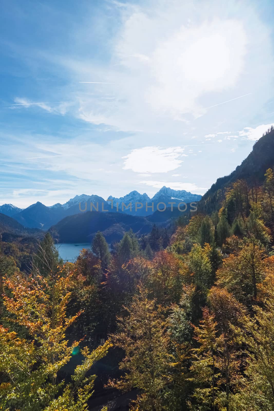 Beautiful nature of European Alps, landscape view of alpine mountains, lake and village on a sunny day, travel and destination scenery