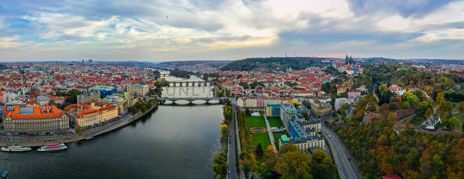 Aerial Prague panoramic drone view of the city of Prague at the Old Town Square, Czechia. Prague Old Town pier architecture and Charles Bridge over Vltava river in Prague at sunset, Czech Republic. 