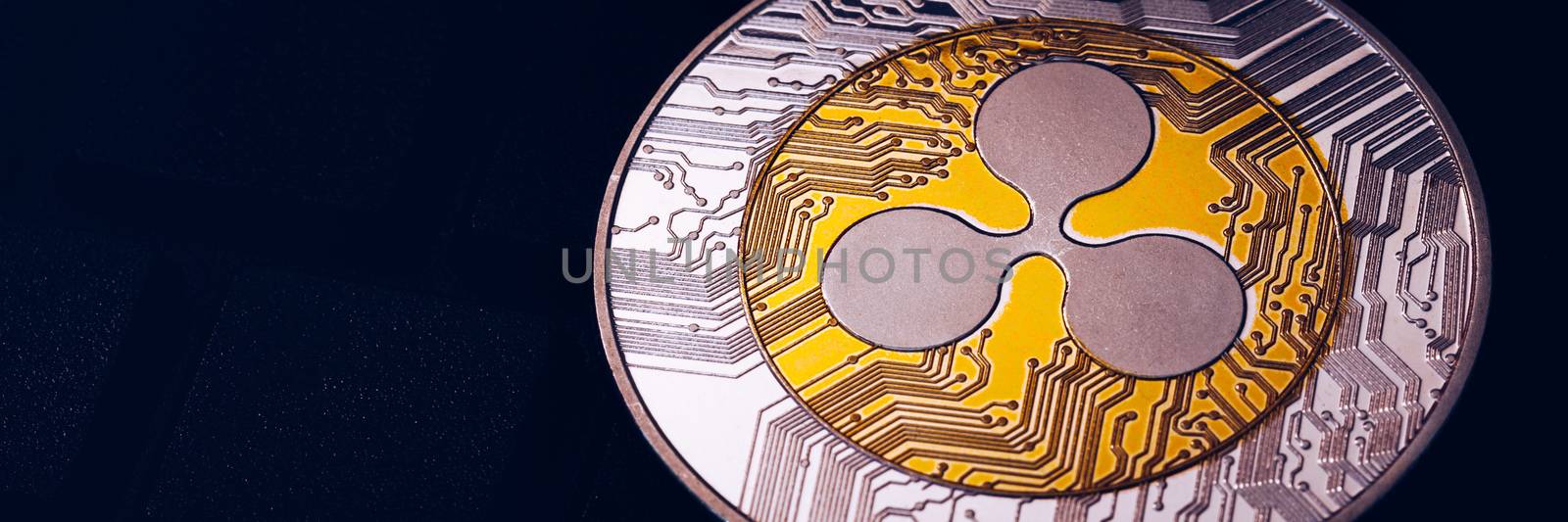 Ripple cryptocurrency (crypto currency). Silver Ripple coin with gold Ripple symbol. Ripple (XRP) cryptocurrency.