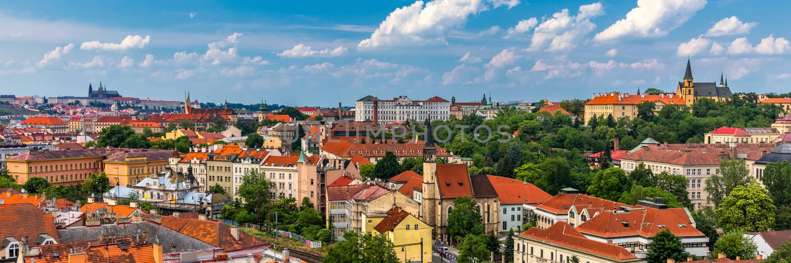 View of Prague Castle over red roof from Vysehrad area at sunset lights, Prague, Czech Republic. Scenic view of Prague city, Prague castle and Petrin tower from Vysehrad overlooking red roofs 