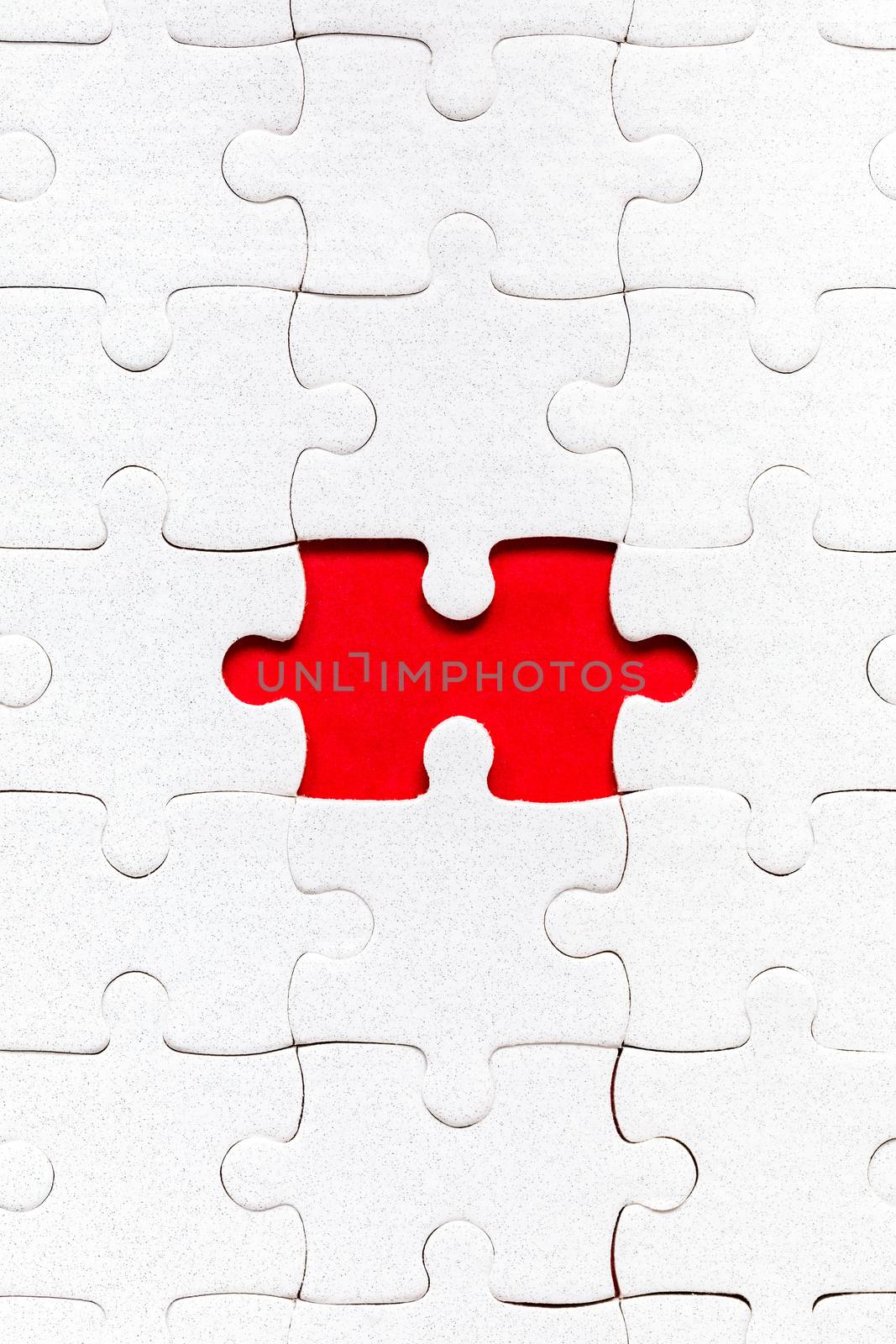 White jigsaw puzzle. White puzzle pieces on color background. Unfinished white jigsaw puzzle pieces on color background. 