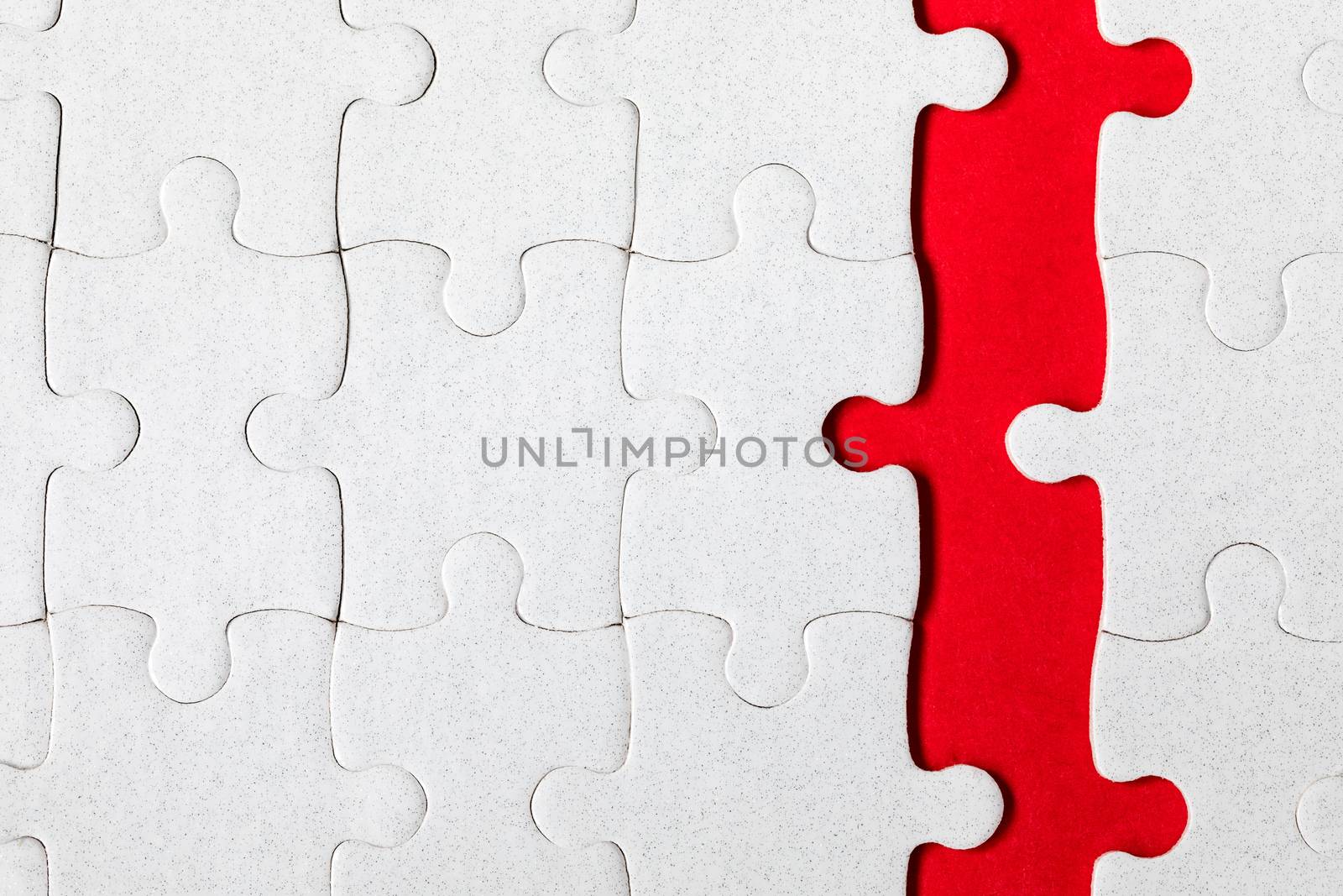 White jigsaw puzzle pieces. Fill in pieces of the jigsaw puzzle. Complete the jigsaw puzzle with the missing pieces. Fragment of a folded white jigsaw puzzle.