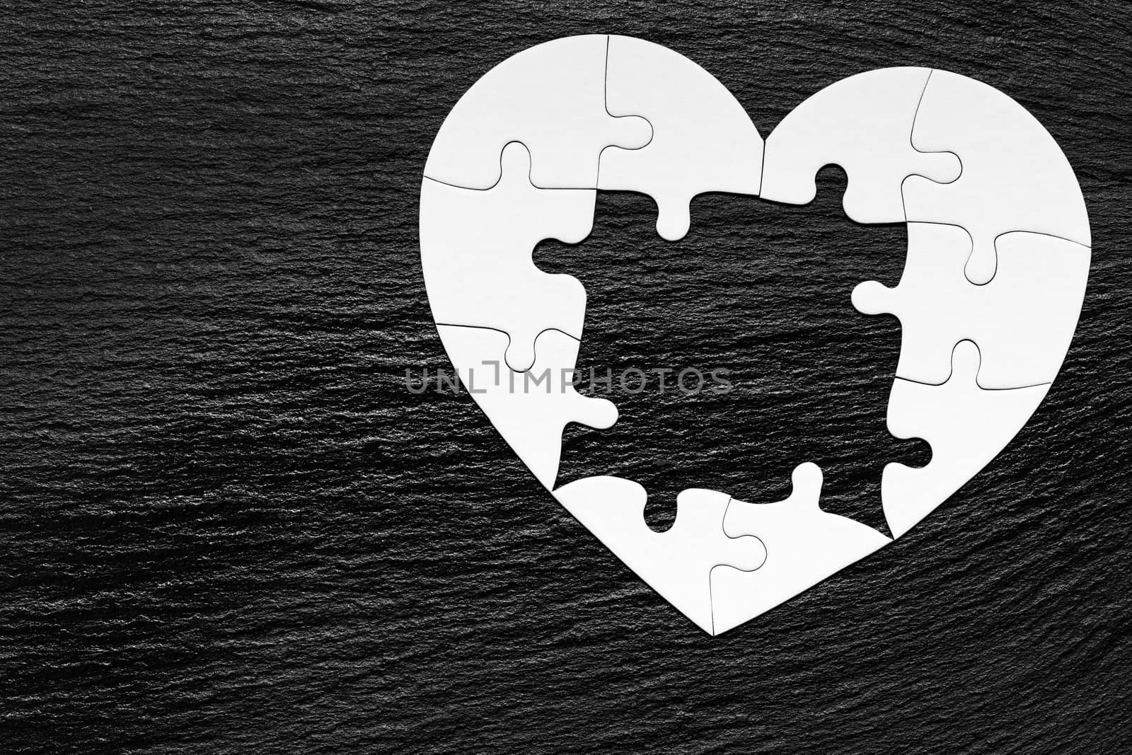 Heart object made of puzzle pieces. Make complete heart. Jigsaw puzzle pieces in form of heart. Happy Valentines Day, greeting card template. Heart jigsaw puzzle.