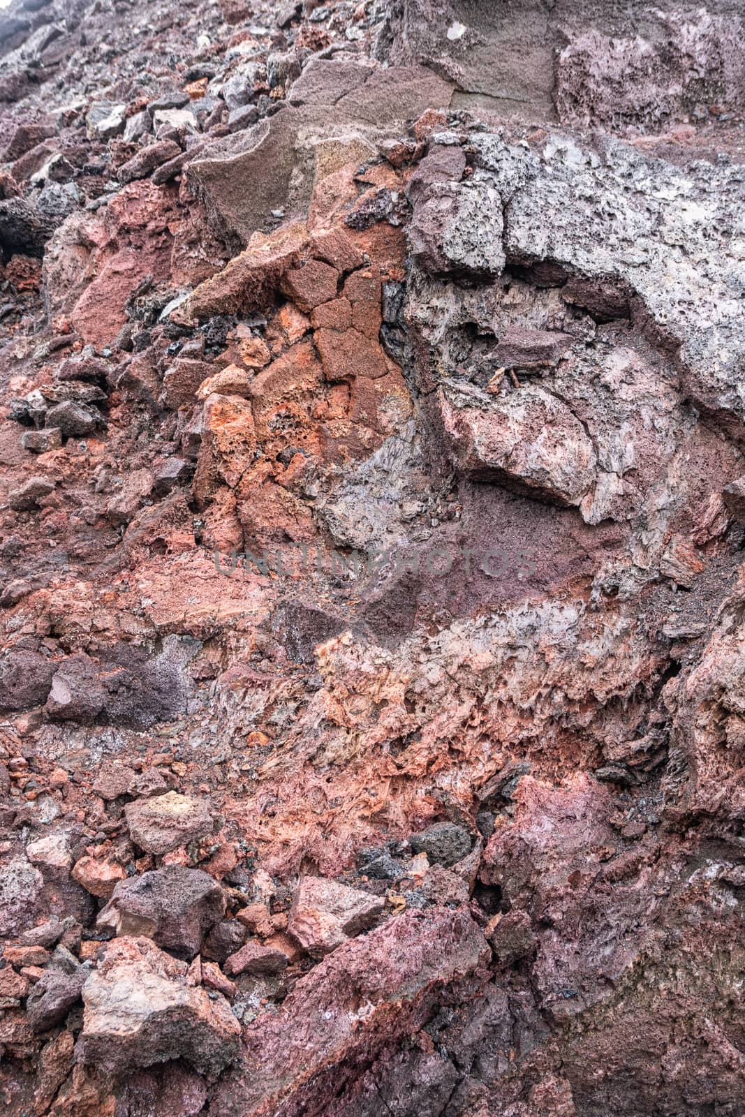 Leilani Estate, Hawaii, USA. - January 14, 2020: 2018 Kilauea volcano eruption hardened black lava field. Closeup portrait of inner red and brown pieces of layer.