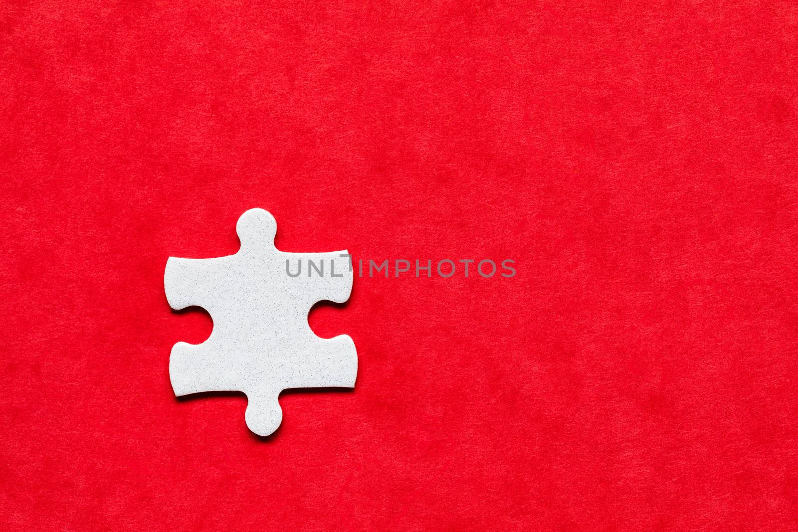White jigsaw puzzle. White puzzle pieces on color background. Unfinished white jigsaw puzzle pieces on color background. 