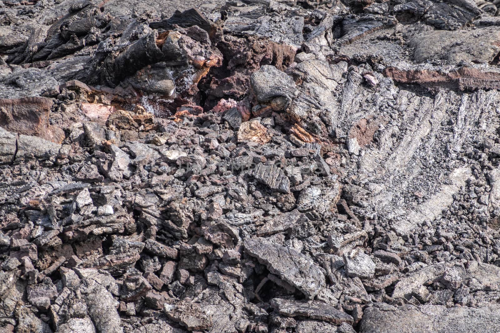 Leilani Estate, Hawaii, USA. - January 14, 2020: 2018 Kilauea volcano eruption hardened black lava field. Closeup of upper crust broken tube-like structures and folds.