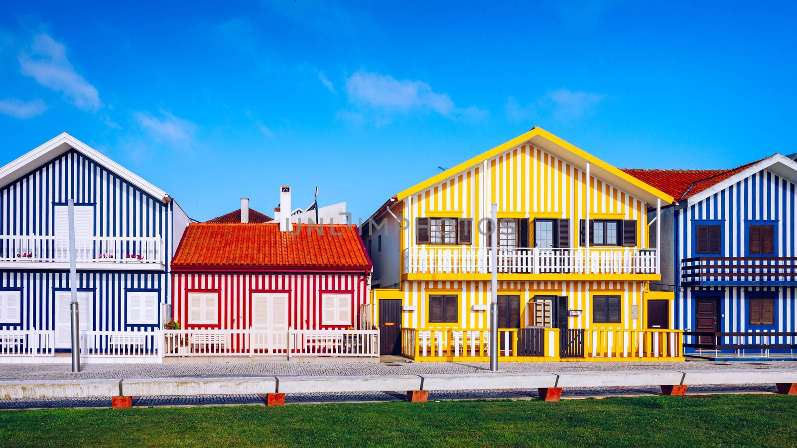 Street with colorful houses in Costa Nova, Aveiro, Portugal. Street with striped houses, Costa Nova, Aveiro, Portugal. Facades of colorful houses in Costa Nova, Aveiro, Portugal.