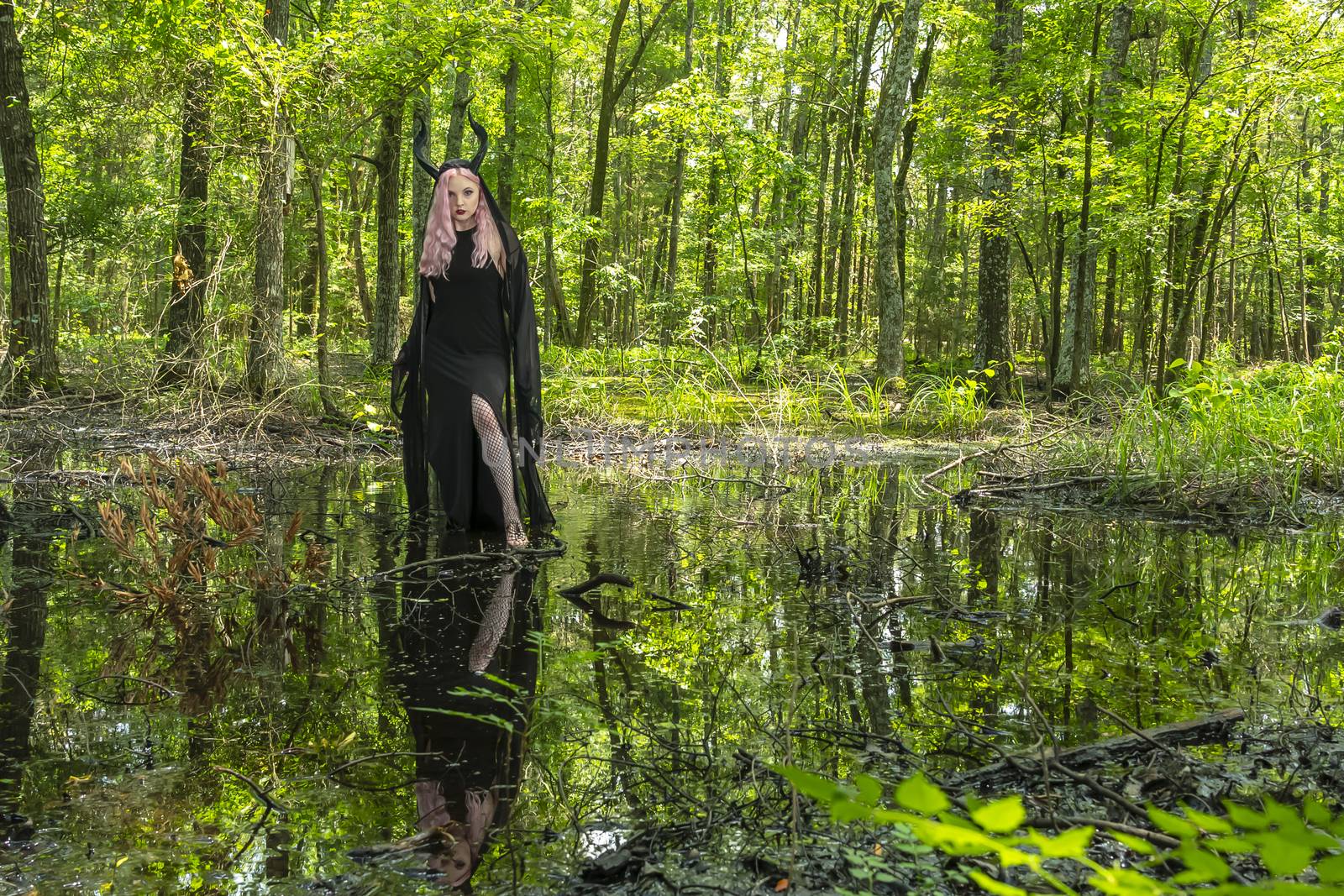 A gorgeous gothic model acts in a forest environment