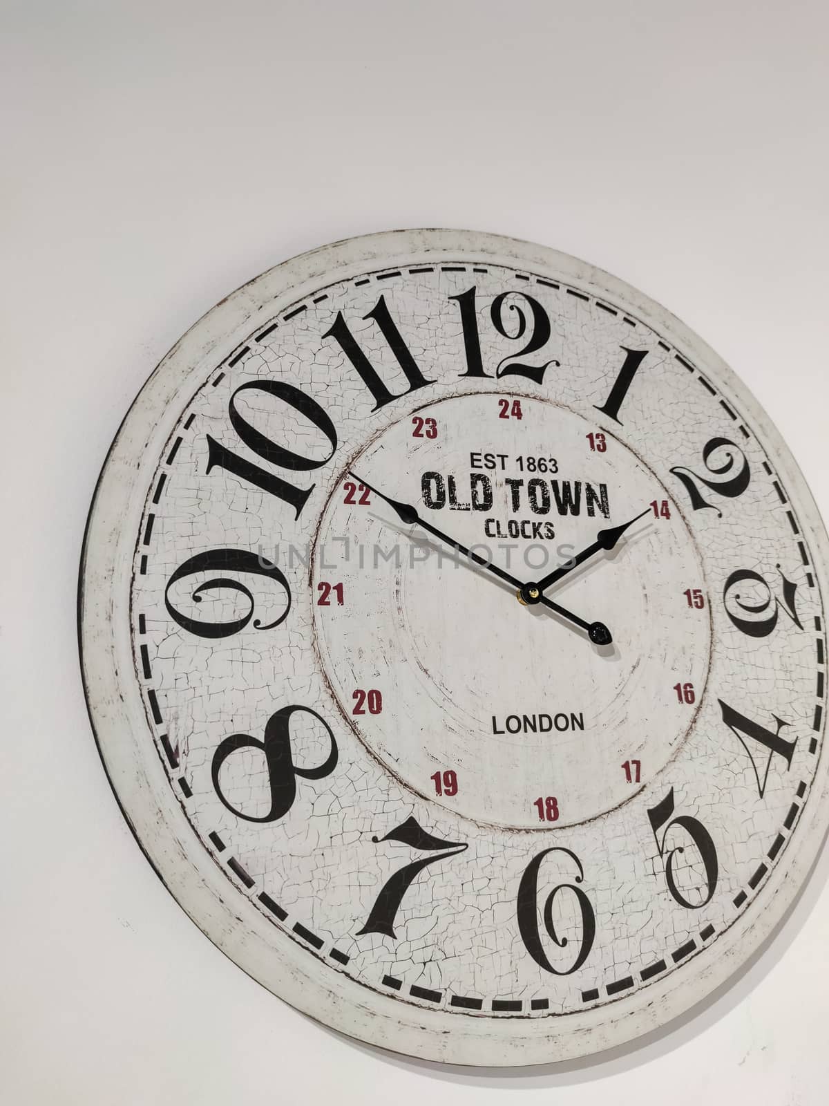 a white clock hanging on the wall.