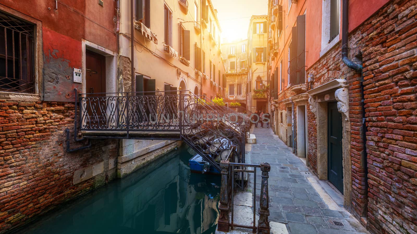 View of the street canal in Venice, Italy. Colorful facades of old Venice houses. Venice is a popular tourist destination of Europe. Venice, Italy.