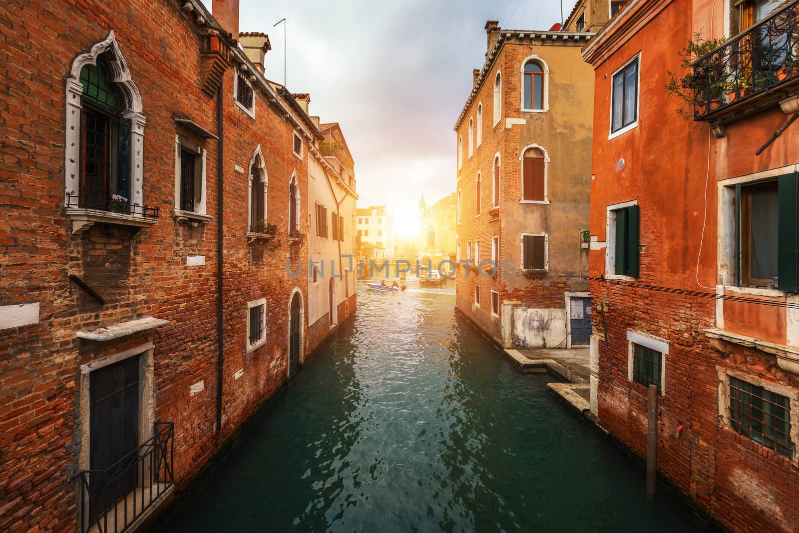 View of the street canal in Venice, Italy. Colorful facades of old Venice houses. Venice is a popular tourist destination of Europe. Venice, Italy.
