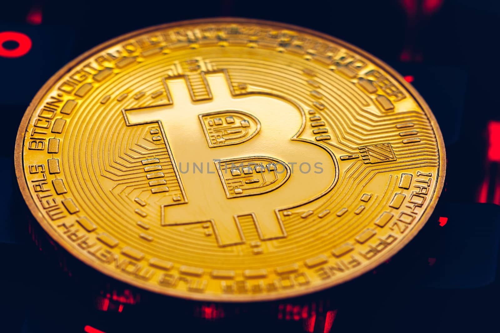 Bitcoin on compuer keyboard in background, symbol of electronic virtual money and mining cryptocurrency concept. Coin crypto currency bitcoin lies on the keyboard. Bitcoin on keyboard.