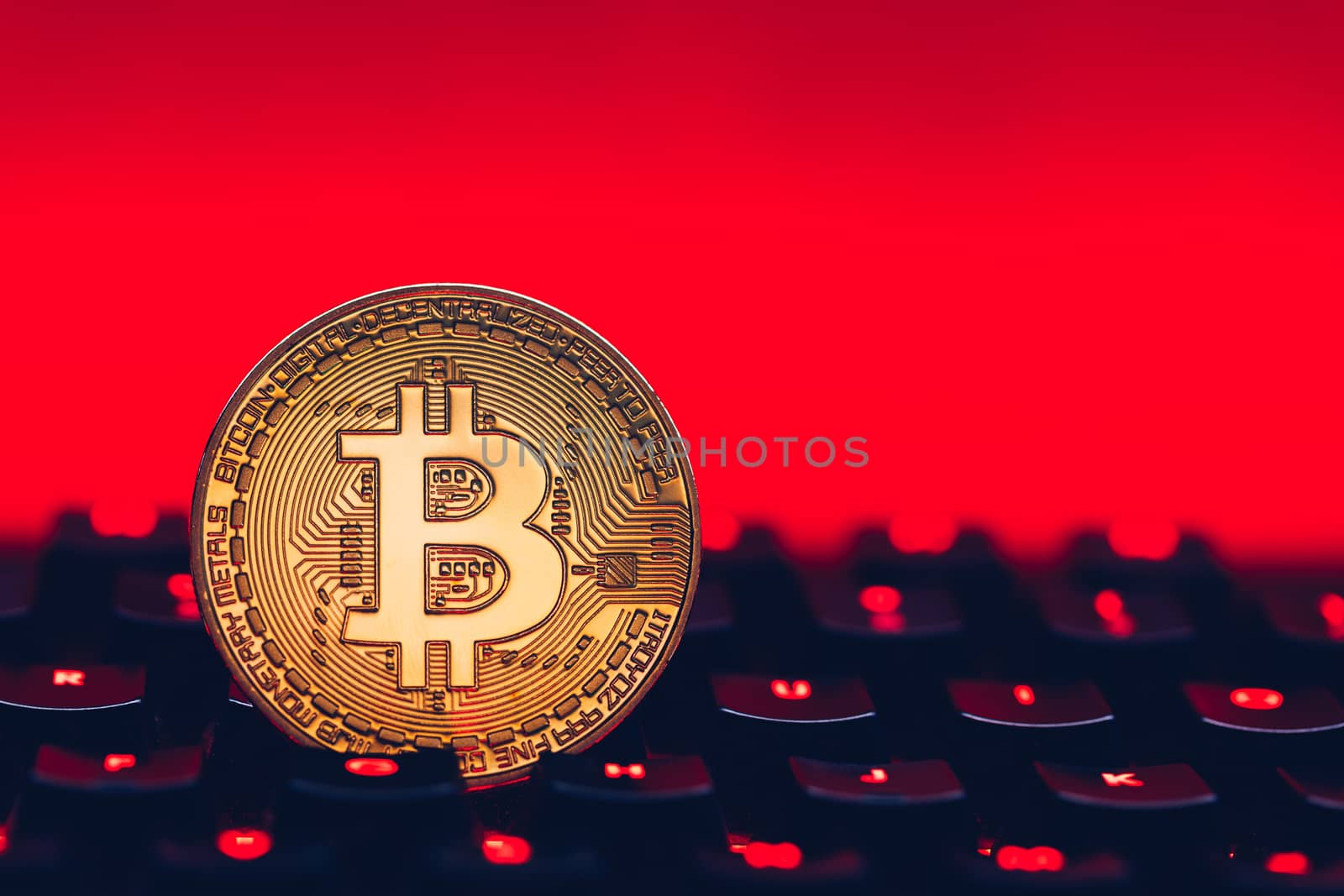 Bitcoin on compuer keyboard in background, symbol of electronic virtual money and mining cryptocurrency concept. Coin crypto currency bitcoin lies on the keyboard. Bitcoin on keyboard.