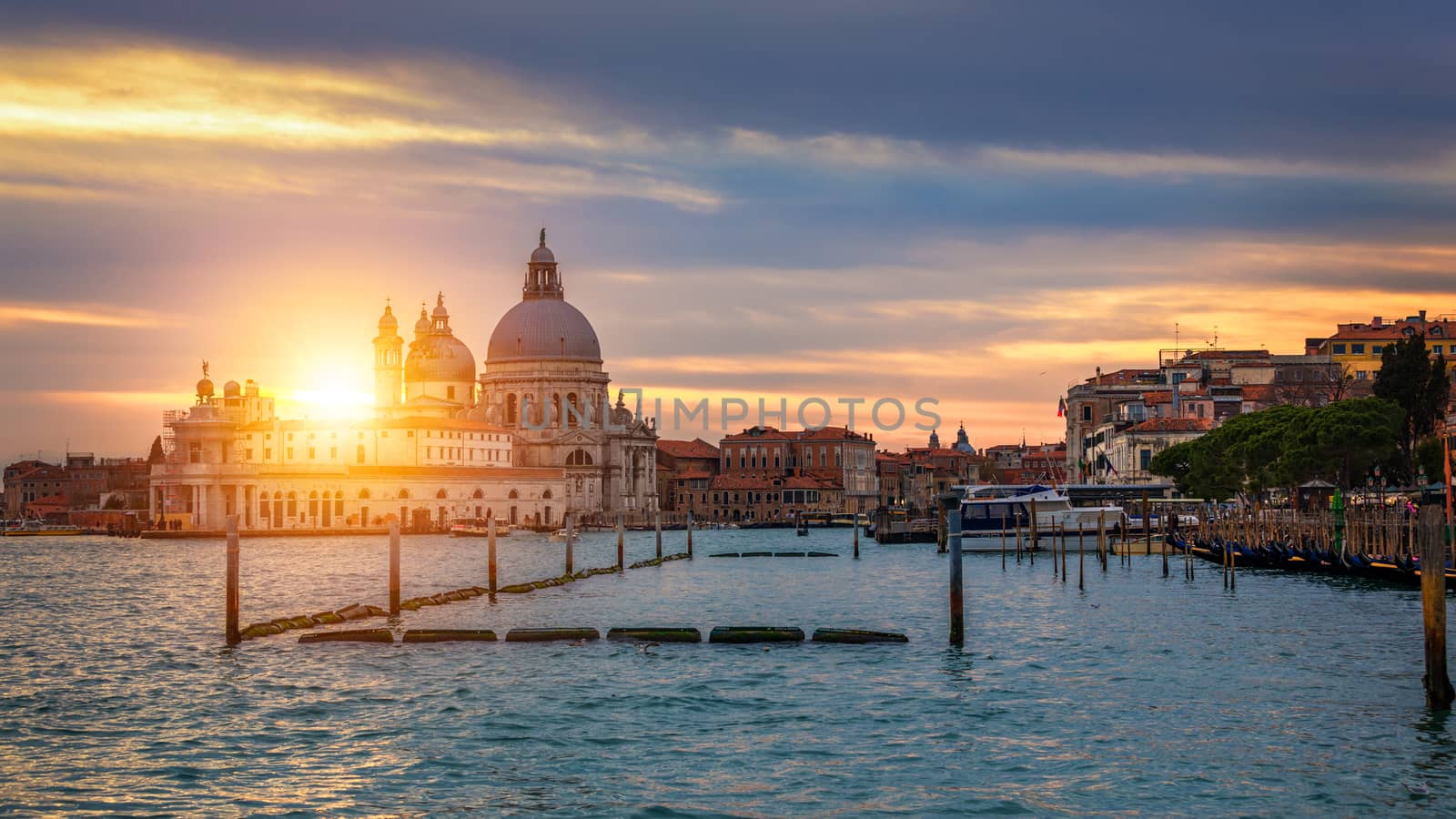 Grand Canal with gondolas in Venice, Italy. Sunset view of Venice Grand Canal. Architecture and landmarks of Venice. Venice postcard