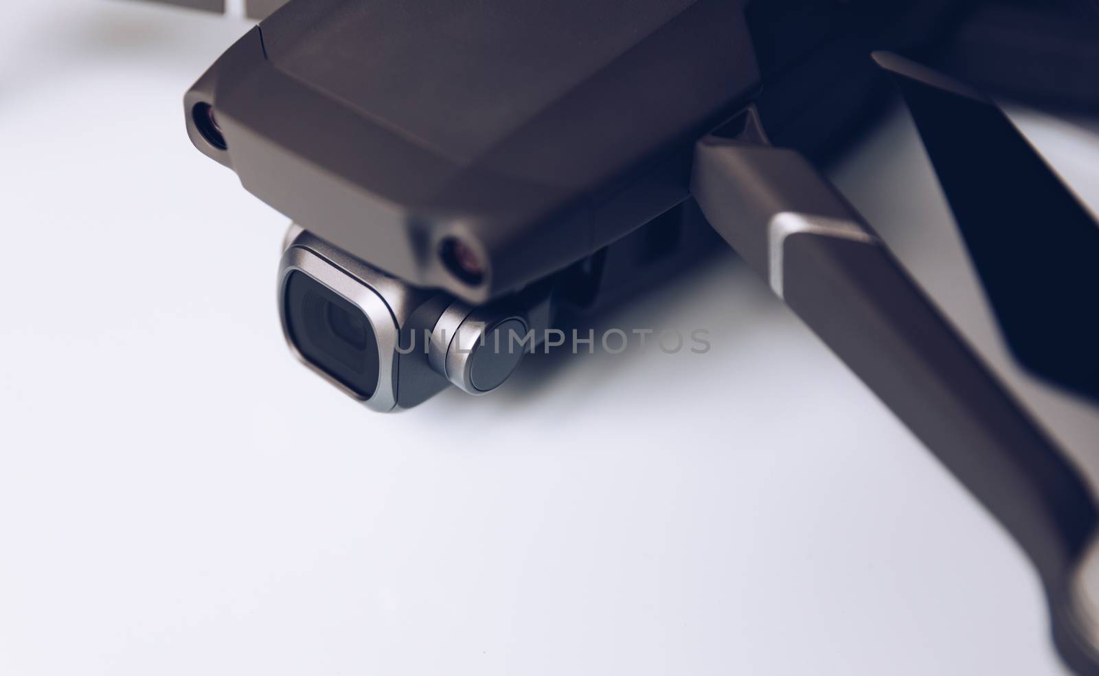 New modern drone on display on white background. Drone quadcopter with digital camera.