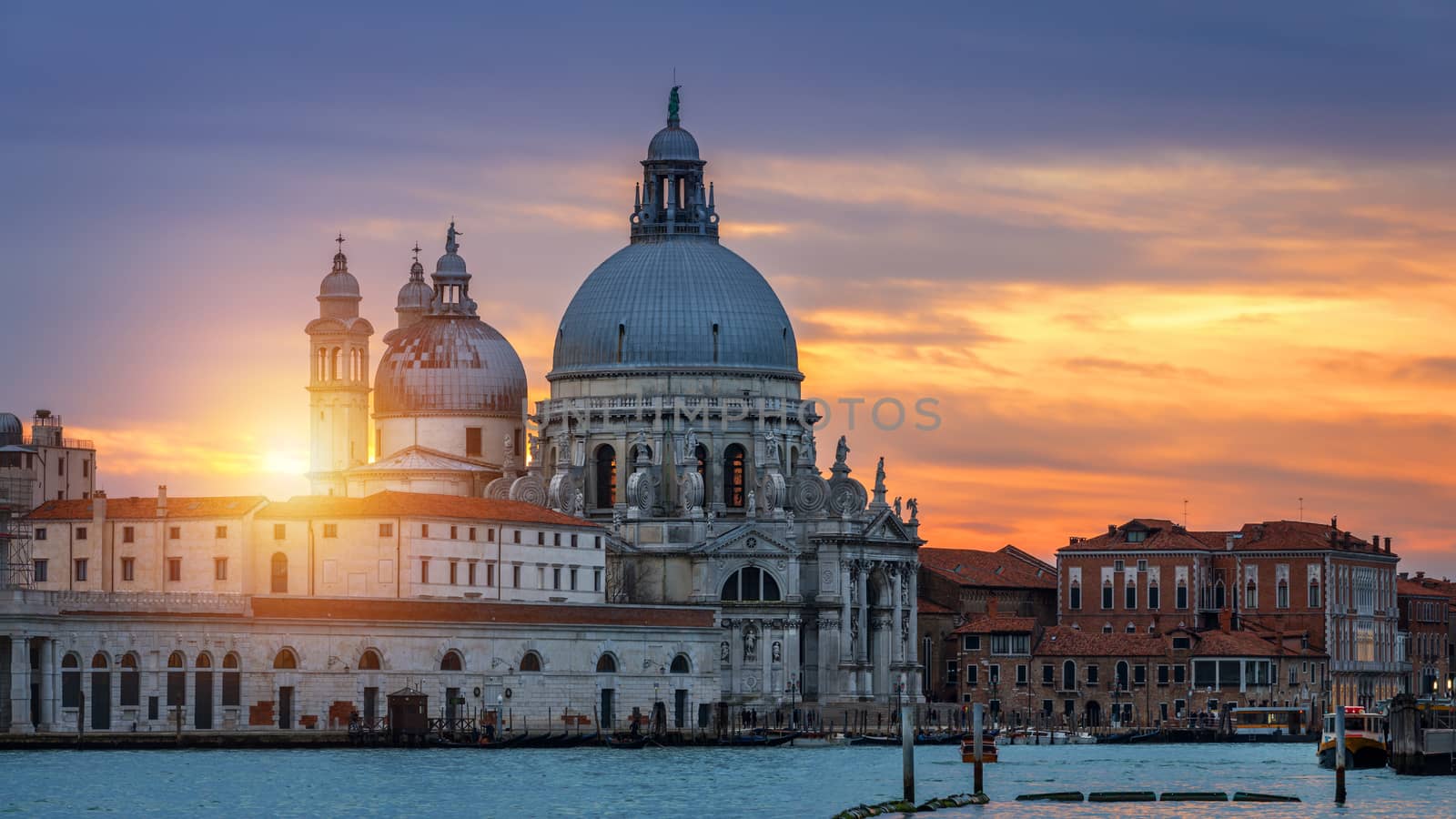 View of the street canal in Venice, Italy. Colorful facades of old Venice houses. Venice is a popular tourist destination of Europe. Venice, Italy.