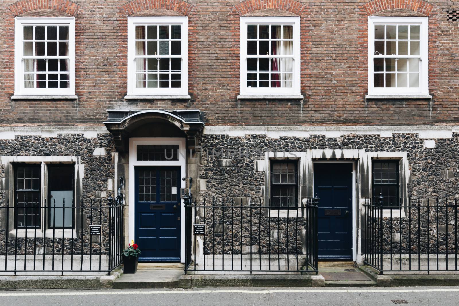 Typical street scene in the central London district with familiar architecture facades to urban housing.