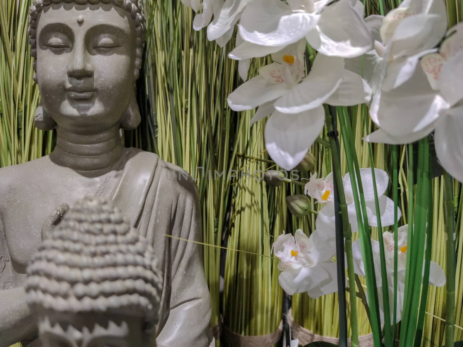  a grey statue of buddha.