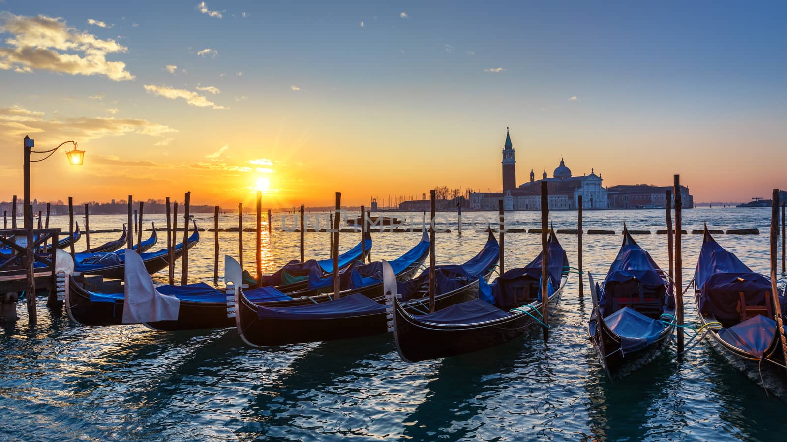 Canal with gondolas in Venice, Italy. Architecture and landmarks of Venice. Venice postcard with Venice gondolas.