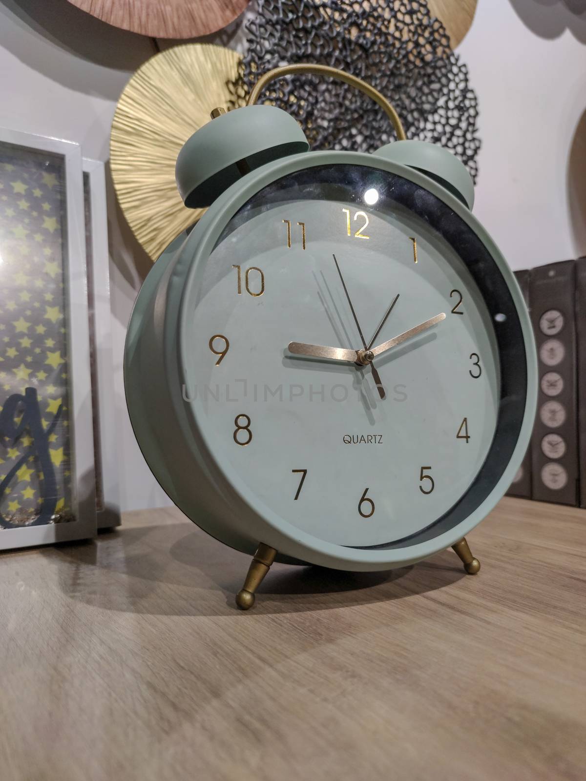 a grey clock on a shelf