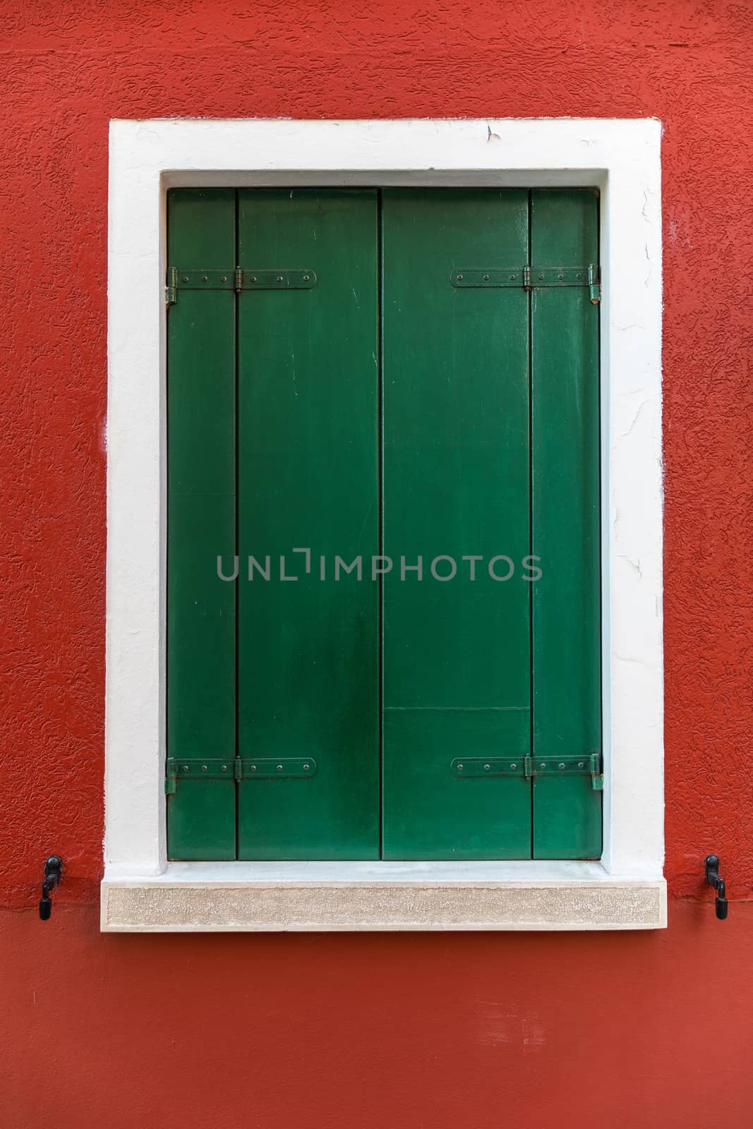 Colorful window of a house on the Venetian island of Burano, Venice. Facade of the houses of Burano close-up. Venice, Italy.