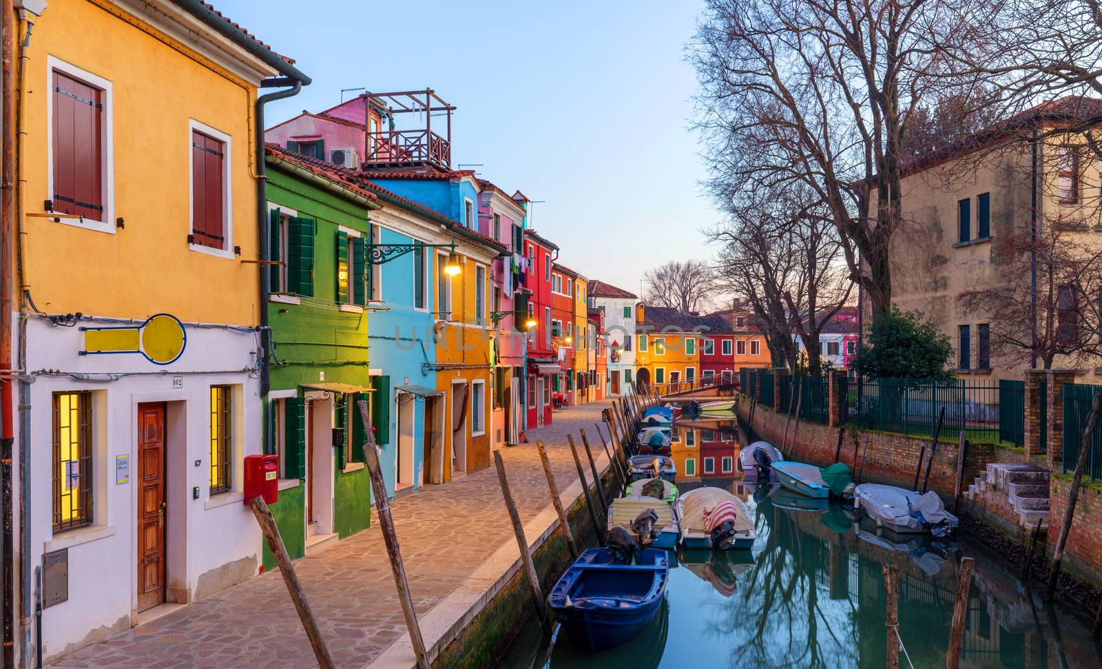 Lovely house facade and colorful walls in Burano, Venice. Burano island canal, colorful houses and boats, Venice landmark, Italy. Europe
