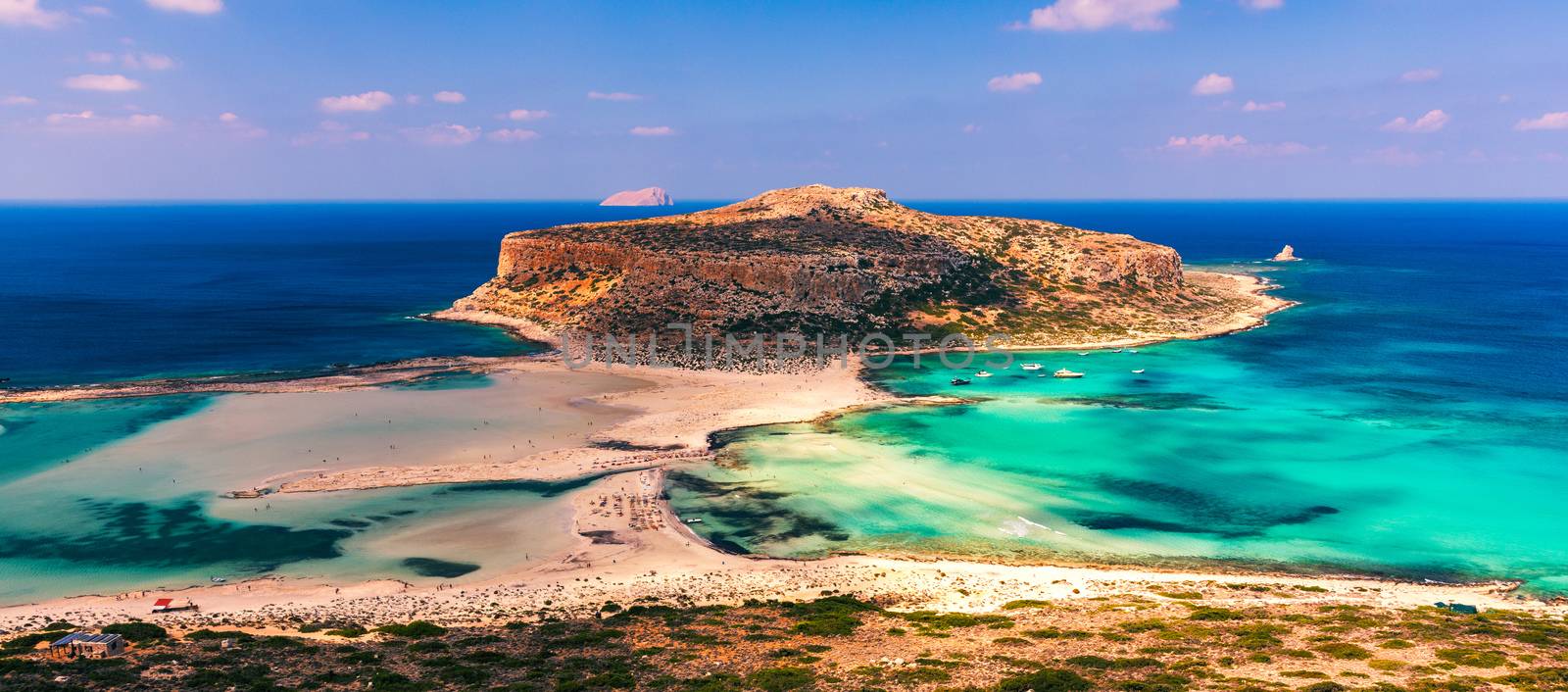 Fantastic panorama of Balos Lagoon and Gramvousa island on Crete, Greece. Cap tigani in the center. Balos beach on Crete island, Greece. Tourists relax and bath in crystal clear water of Balos beach.