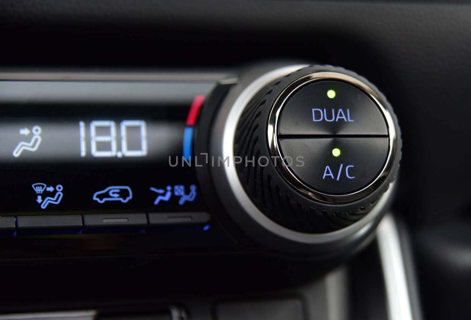 buttons for activating the air conditioners on the dashboard passenger car