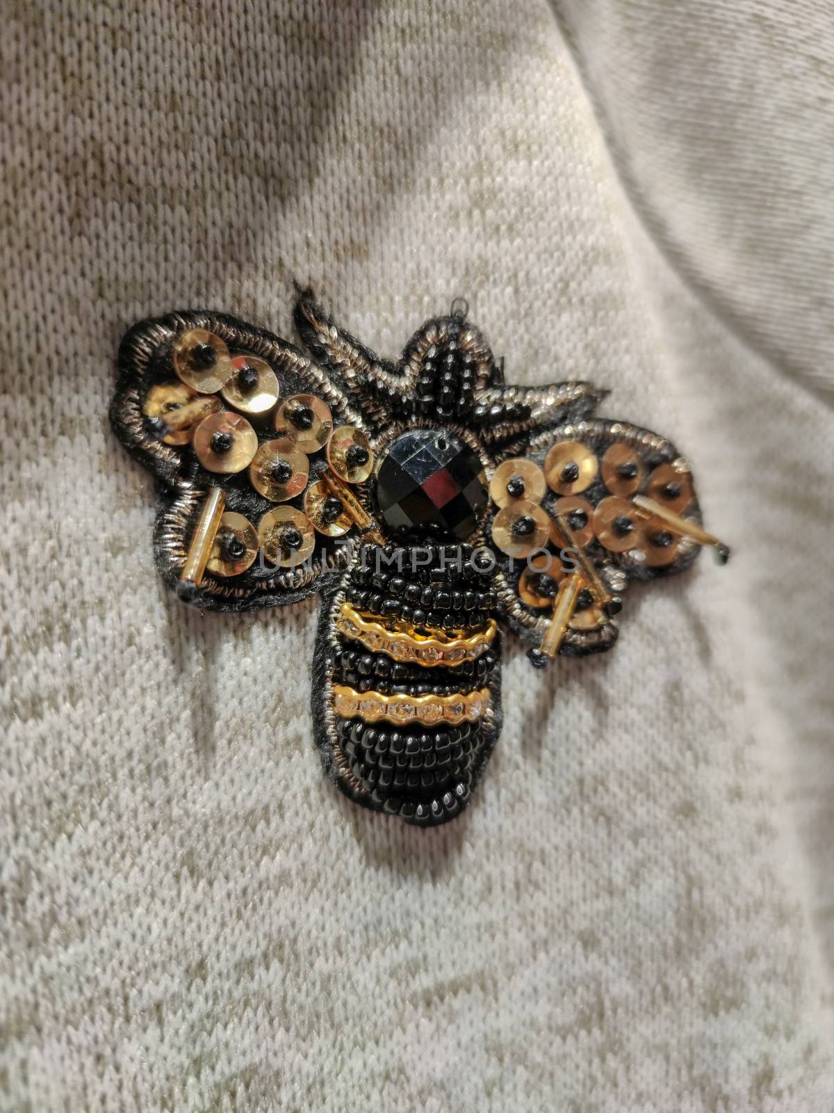 a bee sticker on a sweater by devoxer