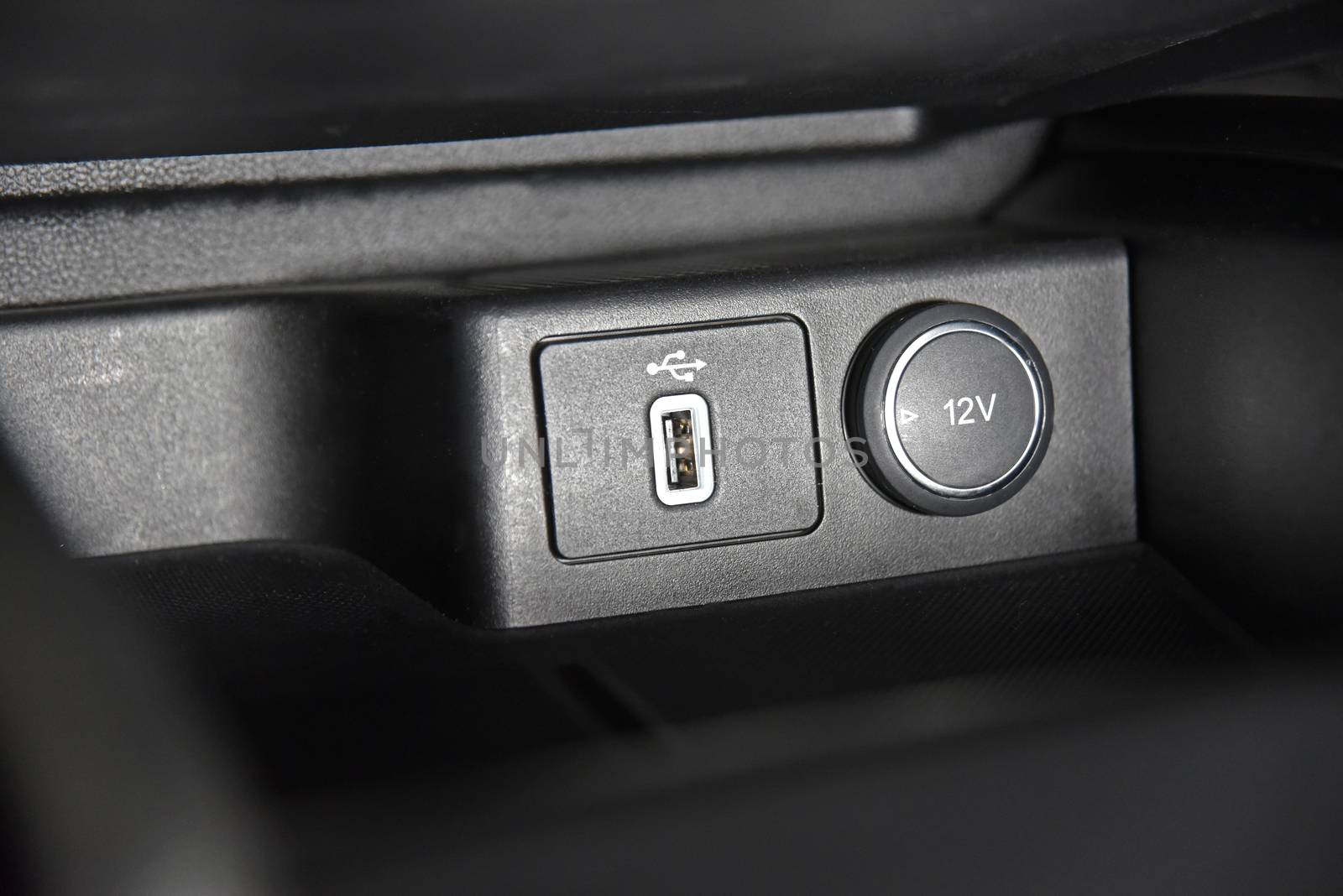 12V socket, wireless mobile phone charger, USB port, AUX port on car dashboard