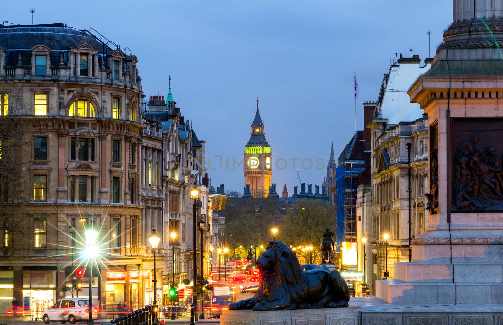 Street view of Trafalgar Square towards Big Ben at night in London, UK