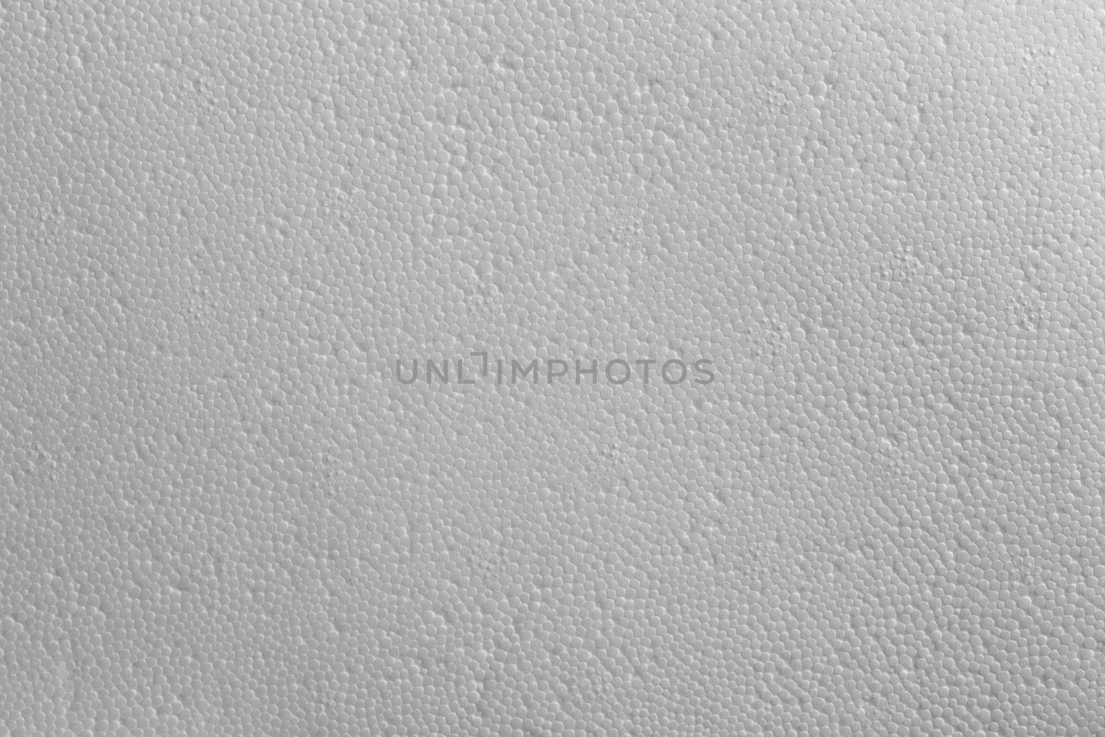 Seamless texture of white polystyrene foam or styrofoam, close-up flat white on white background.