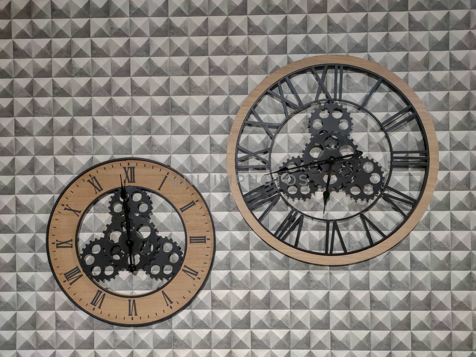 two clocks hanging on the wall