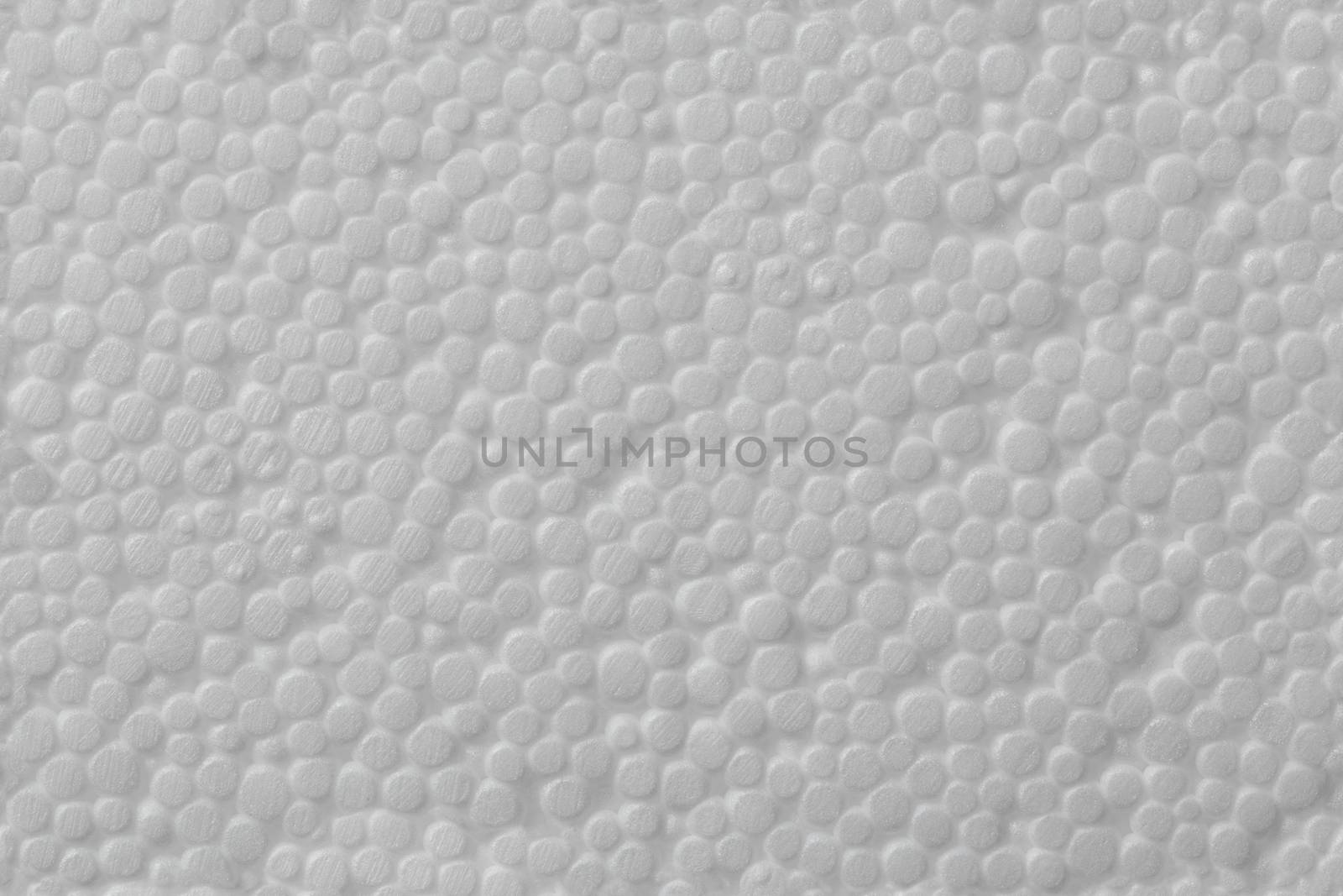 Simple texture of white polystyrene foam or styrofoam, close-up flat white on white background.