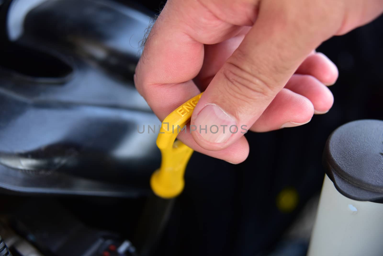 A Person Checking the Motor Oil in Their Car