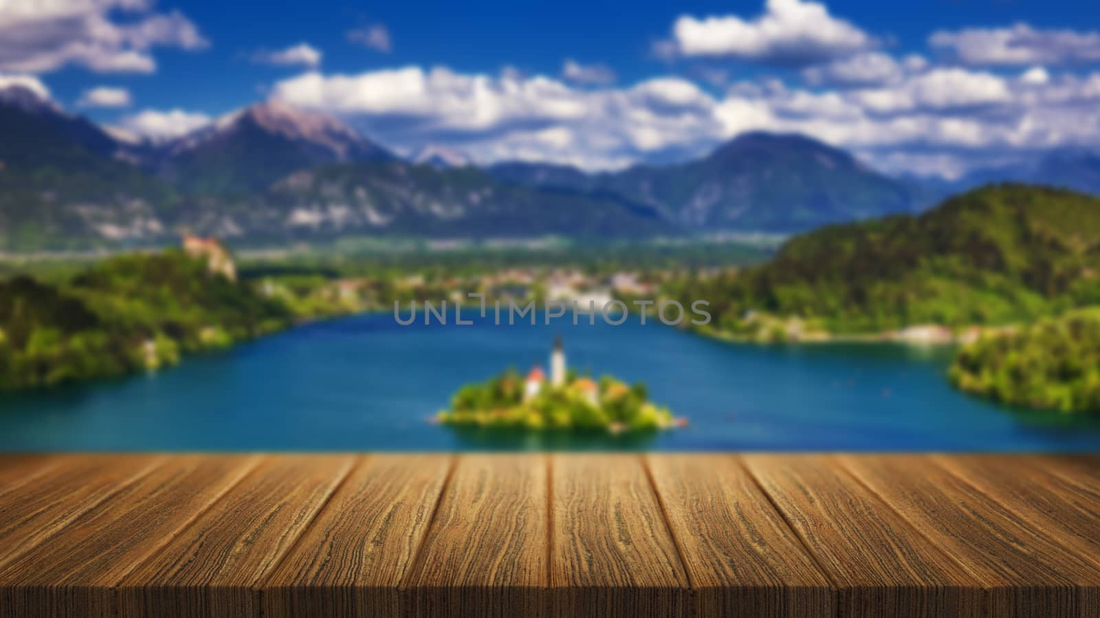Empty wooden table in front of abstract blurred background in nature, can be used for display or montage your products. Mock up for display of product. Bled island in the background from Slovenia.