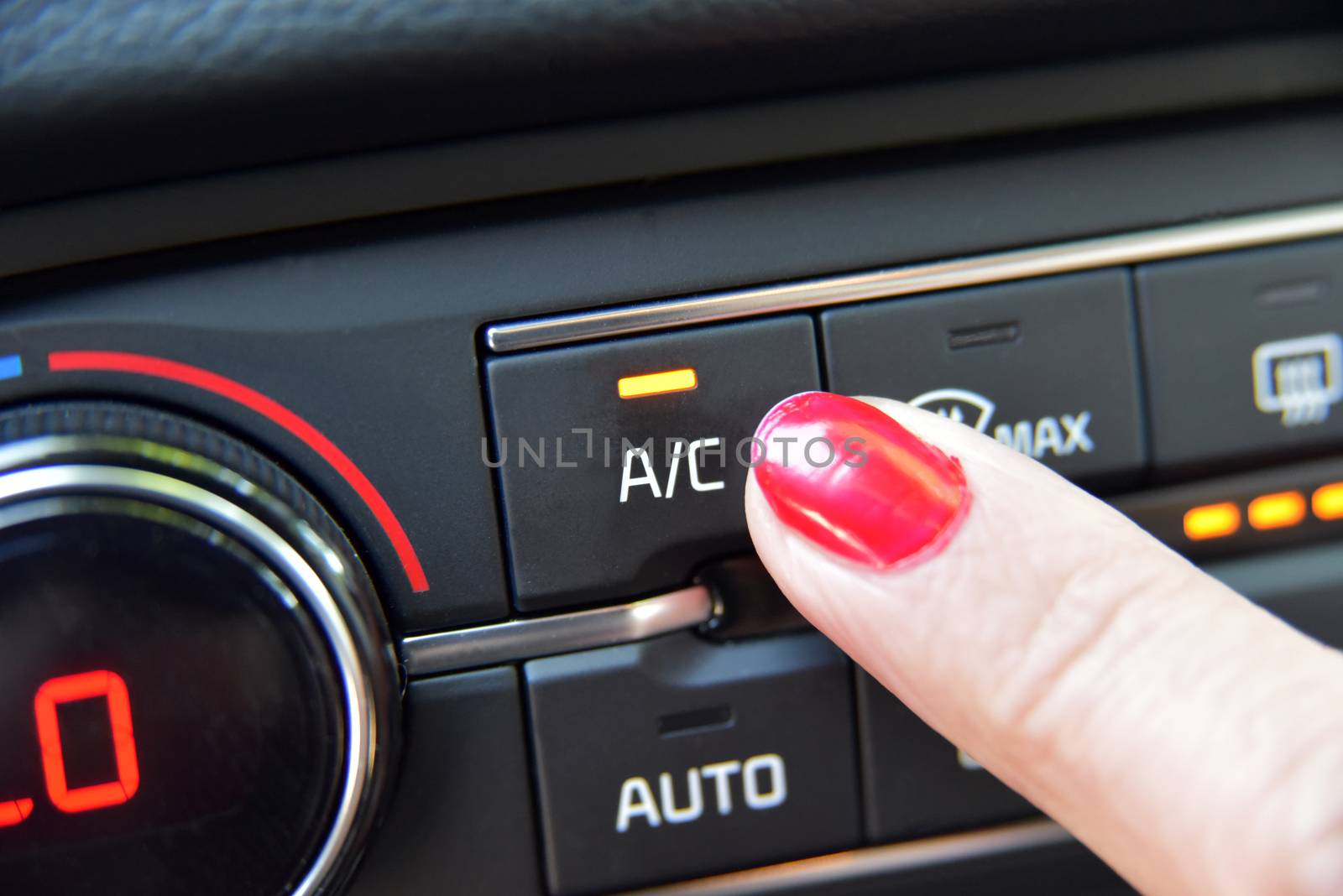Women activates air conditioning in car