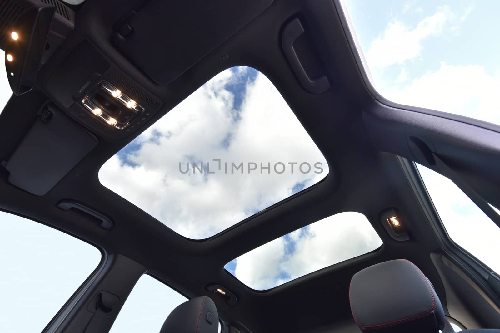 photo large sunroof inside car, sky and clouds