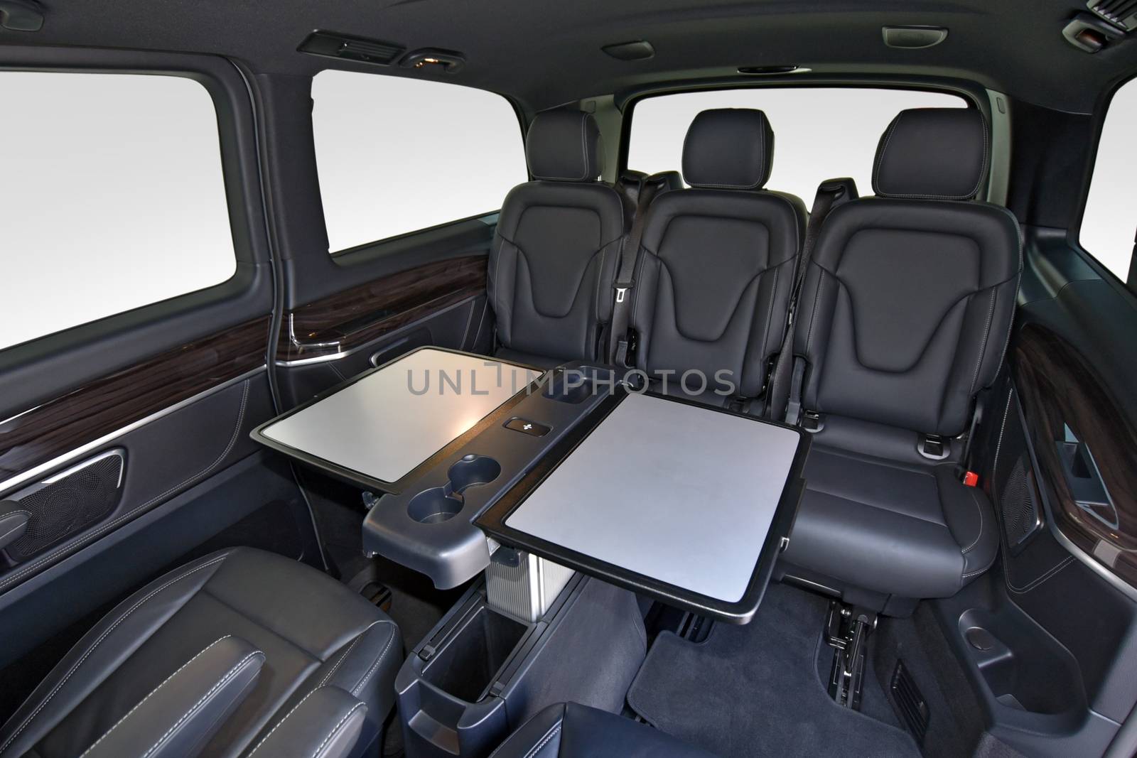 Interior of luxury van with comfortable leather seats and table by aselsa