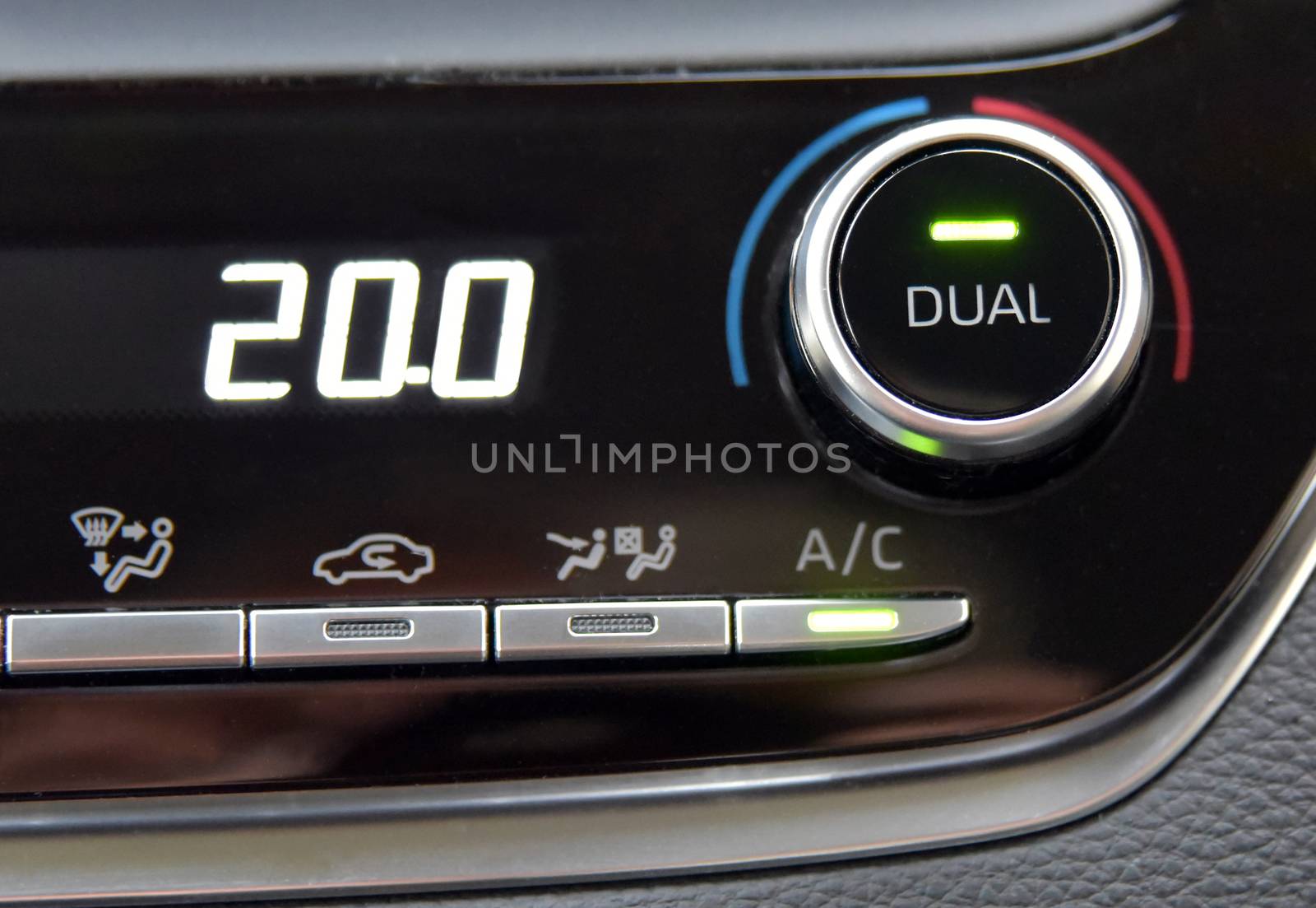 buttons to activate the air conditioning in the car and the temperature gauge