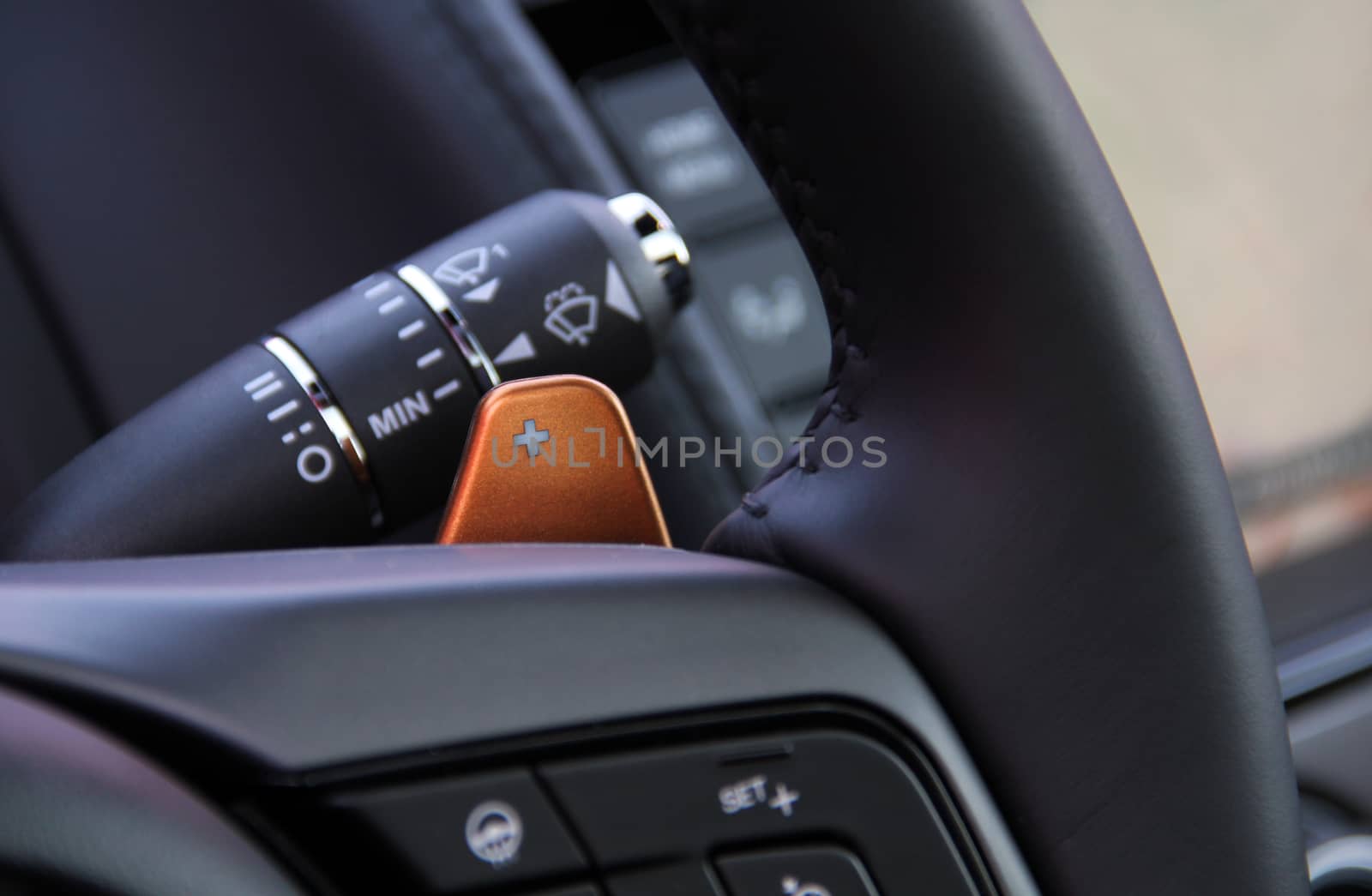 manual gear changing stick on a car's steering wheel, car interior detail