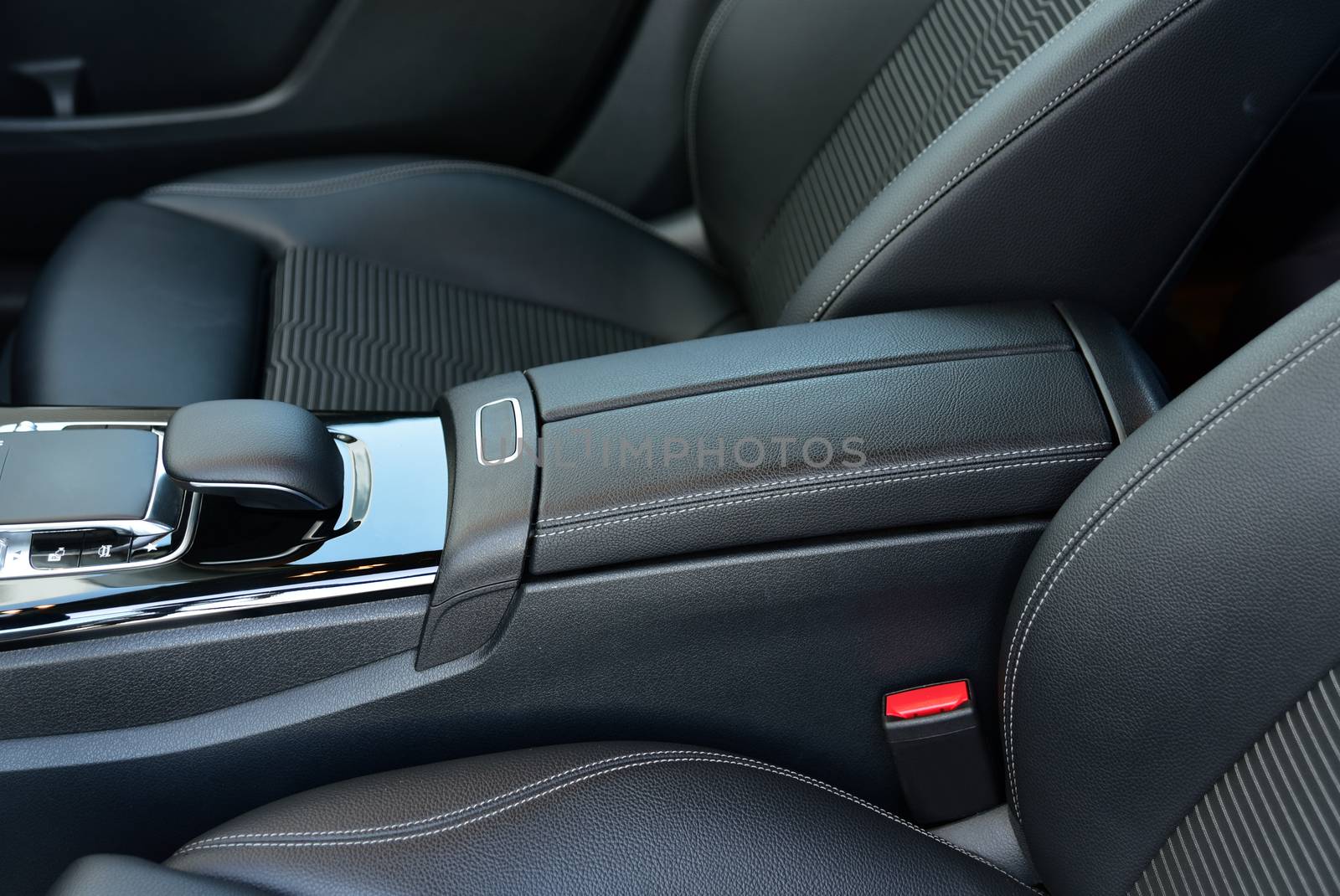 armrest in the luxury passenger car between the front seats