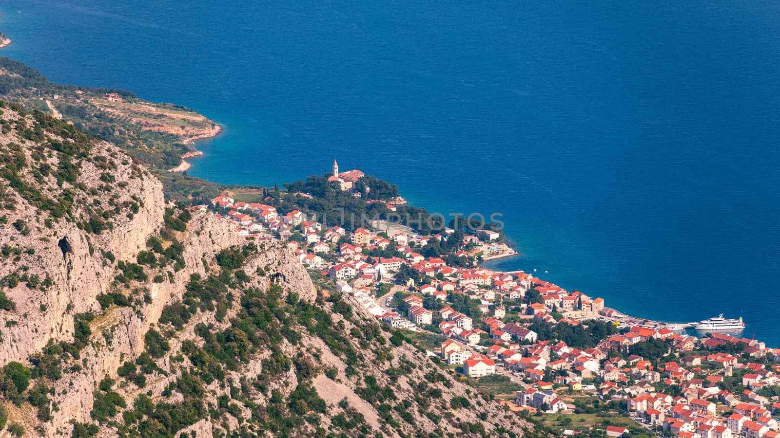 View on mountains and sea from Vidova Gora on Brac island. View from the mountain Vidova Gora on the island Brac in Croatia with the famous landmark Zlatni Rat near the city of Bol an the blue sea.