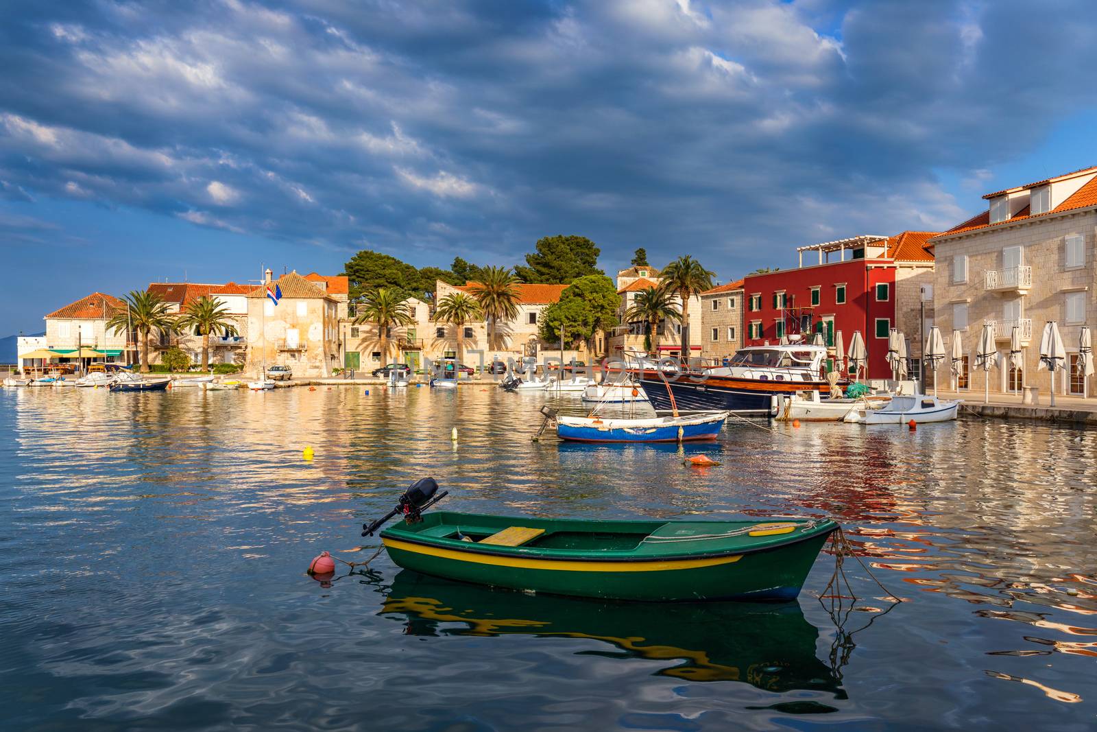 Fishing boat anchoring in beautiful Sutivan port, Brac island, Croatia. Sutivan on Island Brac in Croatia. Made of well known white limestone. Port with fishing boats. Sutivan, Brac, Croatia.