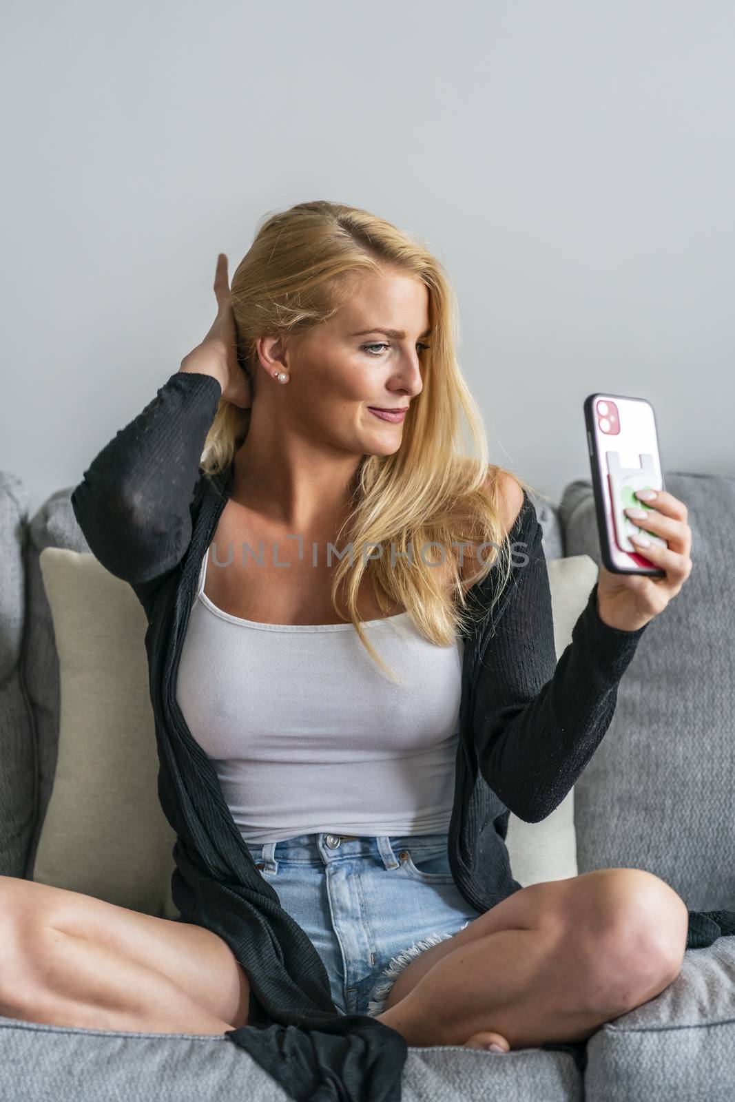 A gorgeous blonde model enjoys a day at home before work