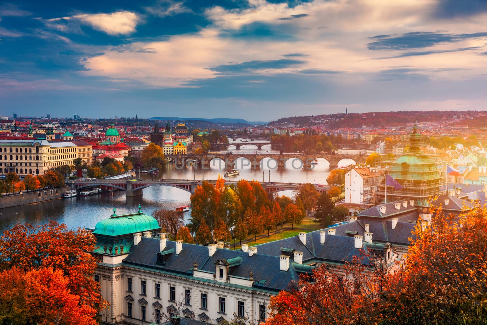 Autumn view to Charles bridge on Vltava river in Prague, Czech Republic. Autumn view to Charles Bridge, Prague old town and Vltava river. Czechia. Scenic autumn view of the Old Town with red foliage.