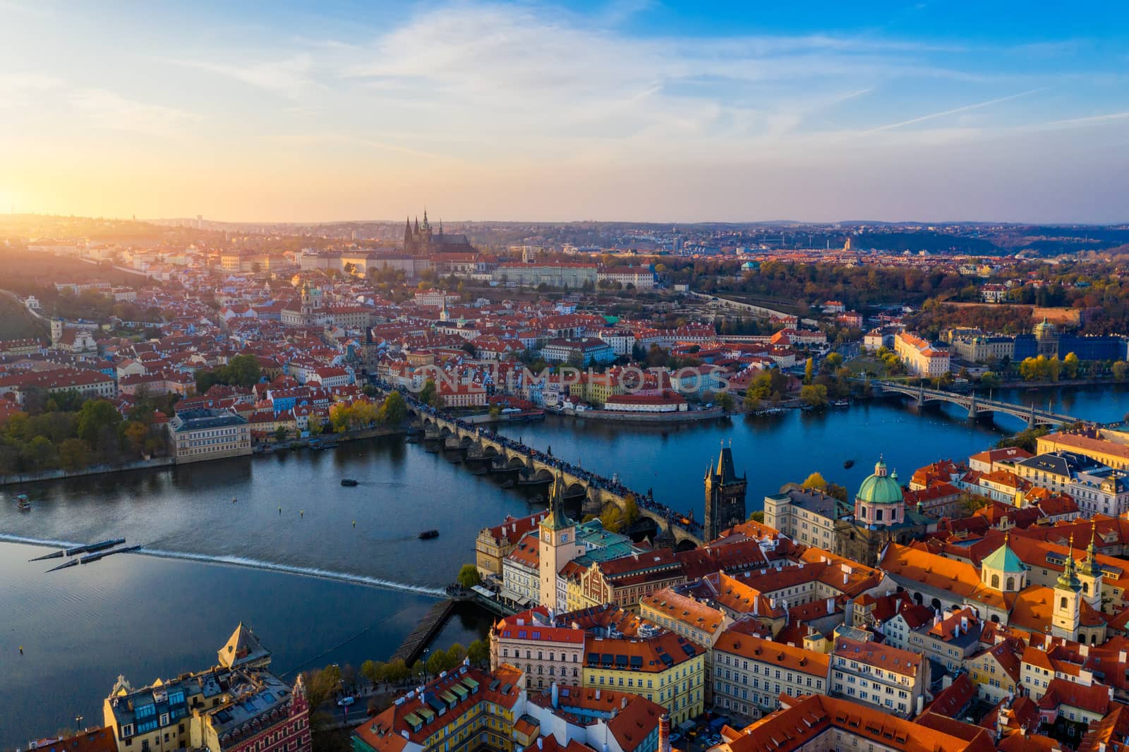 Aerial Prague panoramic drone view of the city of Prague at the Old Town Square, Czechia. Prague Old Town pier architecture and Charles Bridge over Vltava river in Prague at sunset, Czech Republic. 