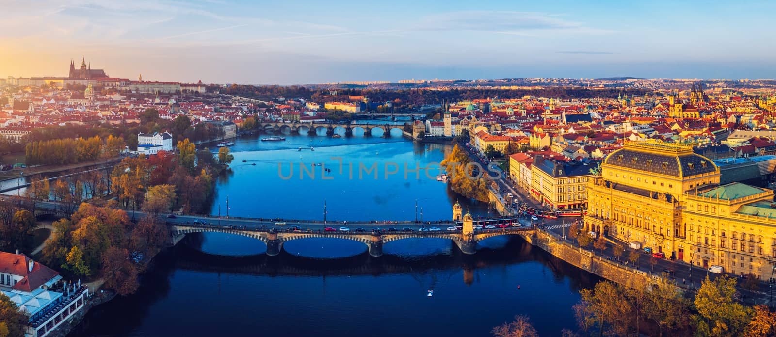 Aerial Prague panoramic drone view of the city of Prague at the Old Town Square, Czechia. Prague Old Town pier architecture and Charles Bridge over Vltava river in Prague at sunset, Czech Republic. 