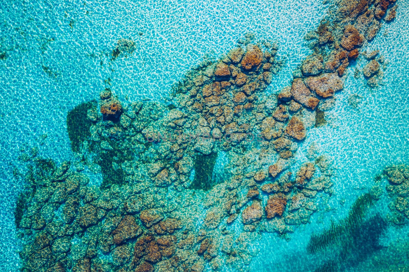 Sea surface aerial view. Background image of the turquoise sea. Deep sea and corals. Aerial drone shot of turquoise water, space for text. Aquamarine background. Sea Aerial view.